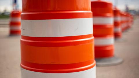 Construction barrels lined up in a work zone.
