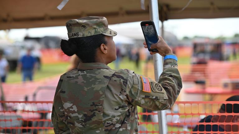 military personnel taking a photo on their phone