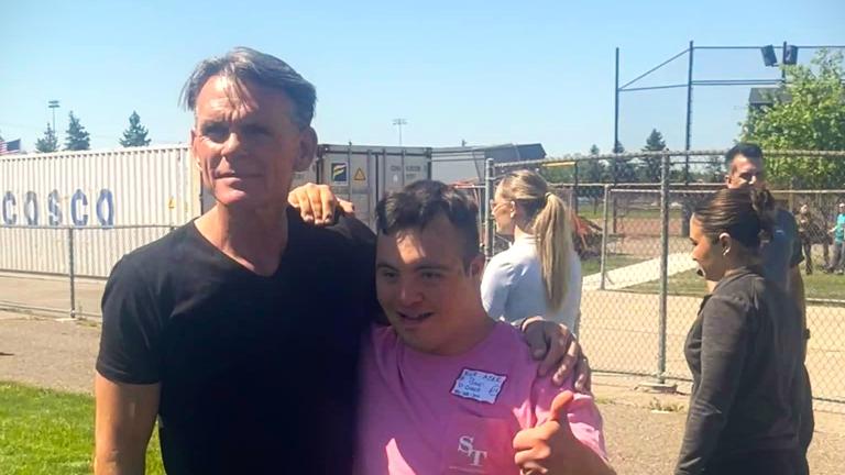 Mark Hackel taking a photo with a Special Olympics participant