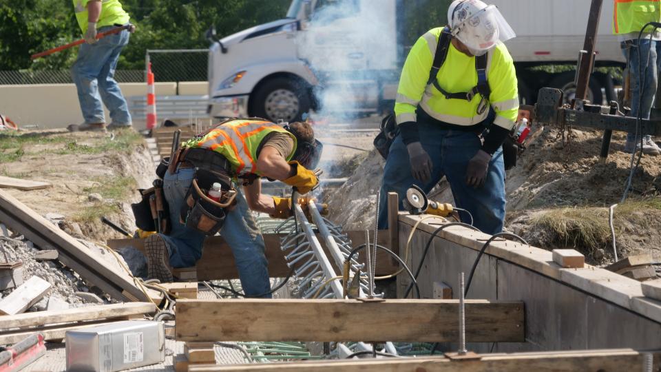 Workers perform utility work on Mound Road