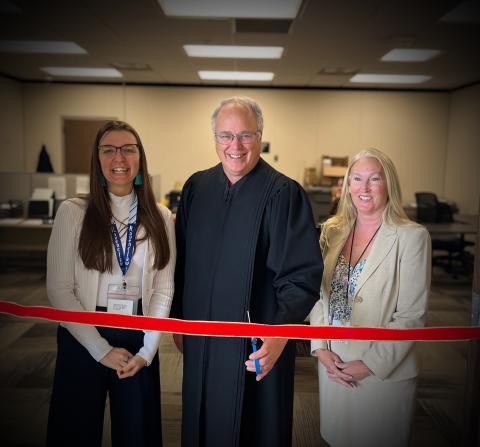 Chief Judge Biernat cutting the ribbon with Legal Services Director Jacqulene Schultz and Deputy Court Administrator Jean Cloud